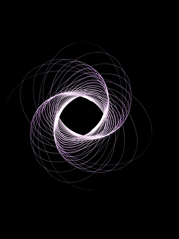 Cover image for the pitch deck cost guide: fine white lines spun into a ring around a dark centre